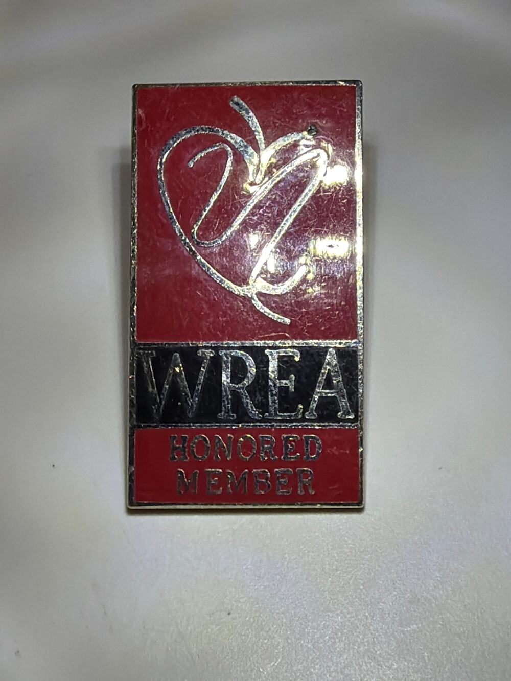 WREA Honored Member Vintage Enamel Lapel Pin Badge Red Black Employee Award
